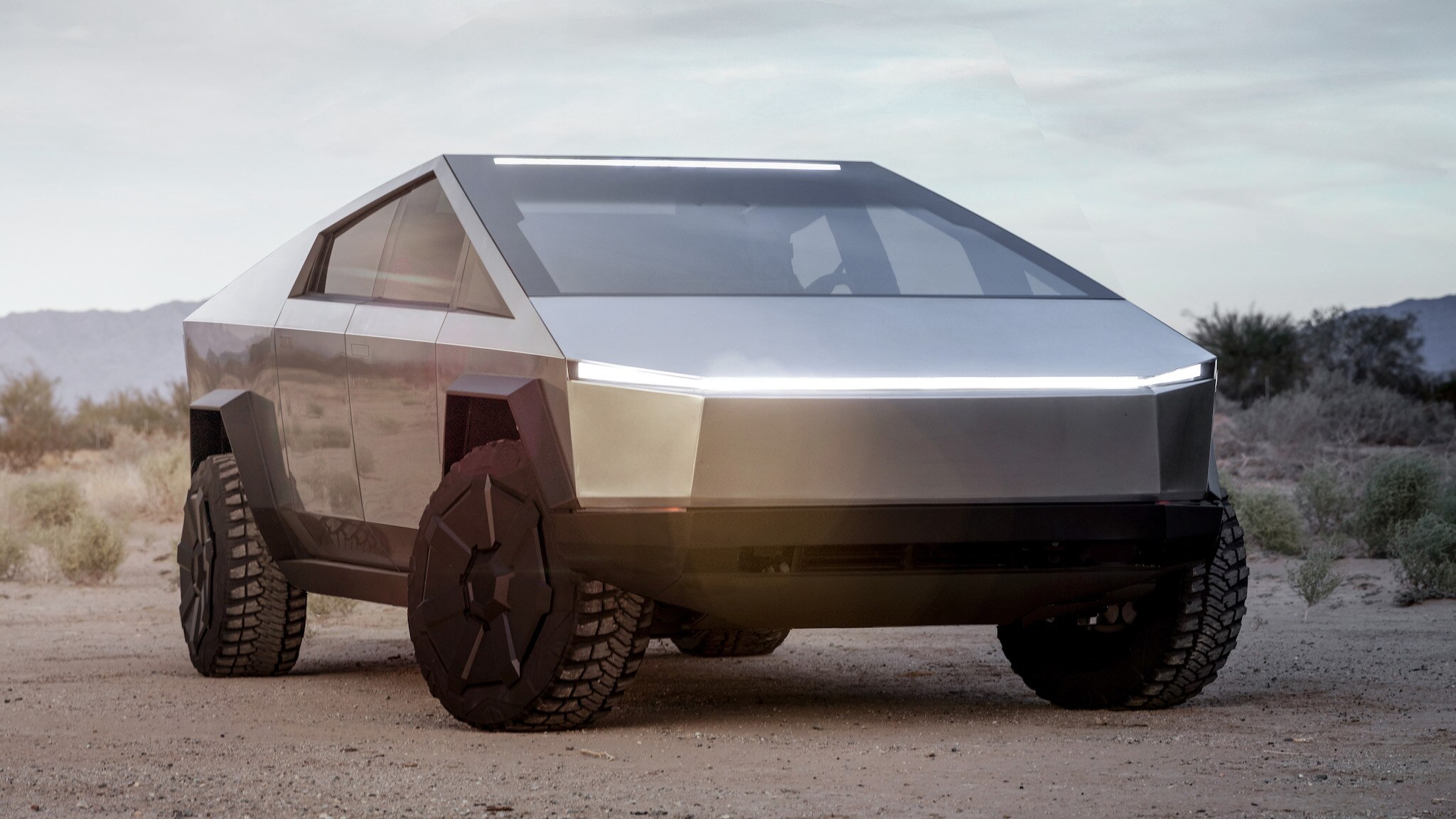 Tesla-Cybertruck-Electric-Pickup-Truck-Front-3-4-View-with-Off-Road-Lights-and-Headlights-Illuminated.jpg